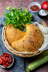 Image showing Pizza calzone with zucchini, dried tomatoes and cheese.