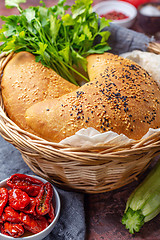 Image showing Homemade pizza calzone in a wicker basket.