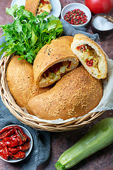 Image showing Fresh calzone pizza in a wicker basket.