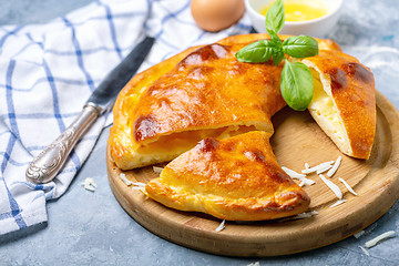 Image showing Cut closed pie with cheese and egg (khachapuri).