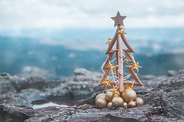 Image showing Christmas tree with gold lights and mountain backdrop