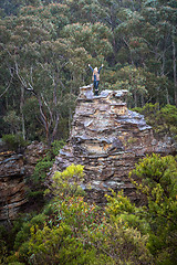 Image showing Hiker exhilaration after climbing a pagoda in mountains