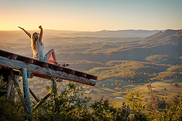 Image showing Freedom loving woman feeling exhilaration on ramp high above the valley