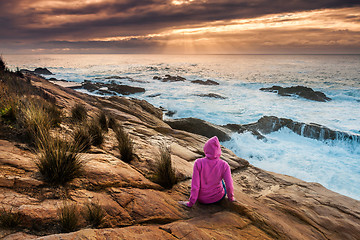 Image showing Woman enjoys views of sunbeams and sea flows