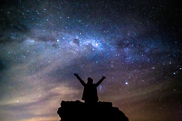 Image showing Silhouetted person hails the cosmos milky way starry night sky