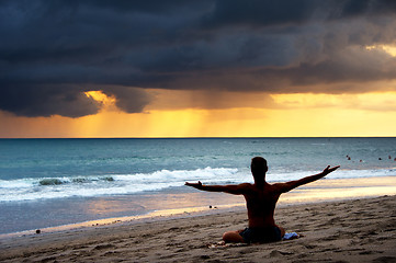 Image showing Man exercising yoga. Bali,  beach