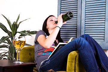 Image showing Cute Girl Drinking while Reading a Book