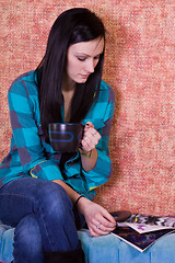 Image showing Teenager Drinking Coffee and Reading Magazine