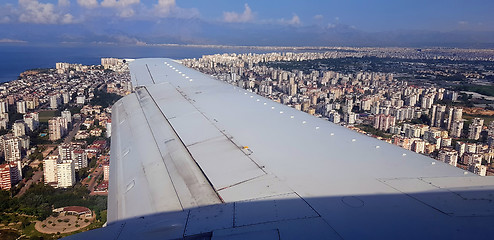 Image showing Plane flying above city