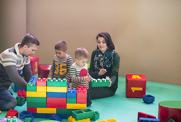 Image showing young parents and kids having fun at childrens playroom