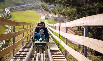 Image showing young father and son driving alpine coaster