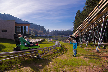 Image showing Happy family enjoying alpine coaster