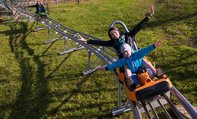 Image showing young mother and son driving alpine coaster