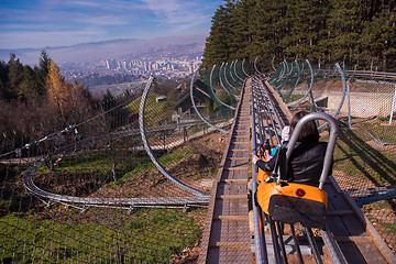 Image showing young mother and son driving alpine coaster