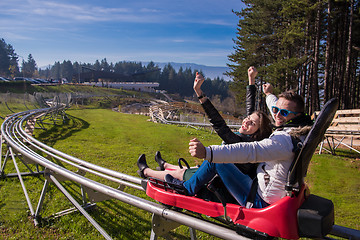 Image showing couple driving on alpine coaster