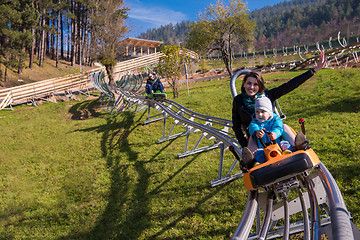 Image showing young mother and son driving alpine coaster