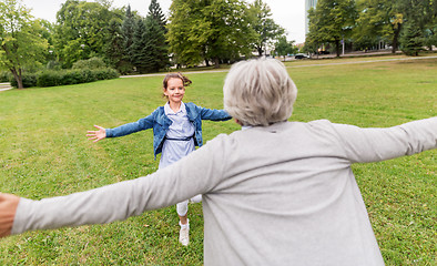 Image showing grandmother and granddaughter playing at park