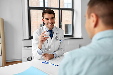 Image showing doctor showing medicine to patient at hospital