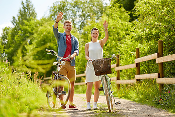 Image showing happy couple with bicycles at summer park