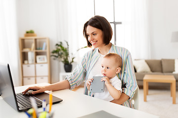 Image showing working mother with baby boy and laptop at home