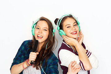 Image showing teenage girls in earphones listening to music