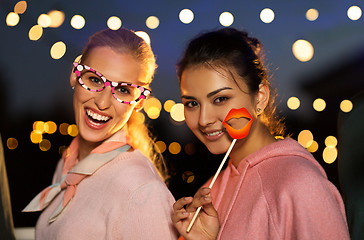 Image showing happy women with party props at night