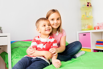 Image showing happy little kids hugging at home