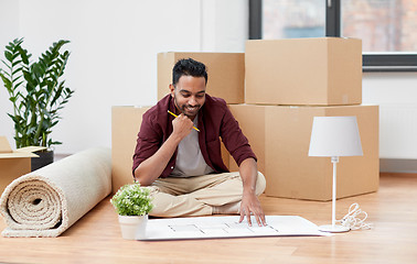 Image showing man with boxes and blueprint moving to new home