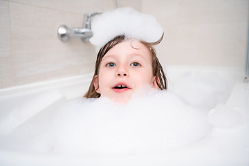 Image showing little girl in bath playing with foam