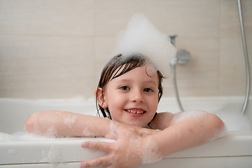 Image showing little girl in bath playing with foam