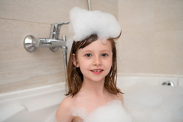 Image showing little girl in bath playing with foam