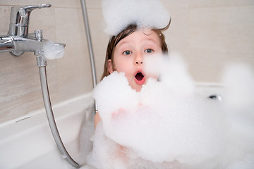 Image showing little girl in bath playing with foam