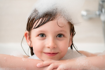 Image showing little girl in bath playing with foam