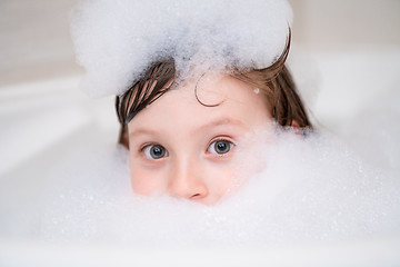 Image showing little girl in bath playing with foam