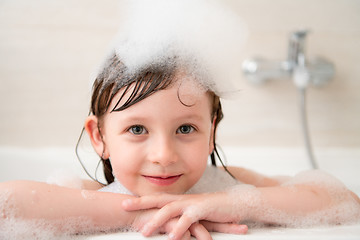 Image showing little girl in bath playing with foam