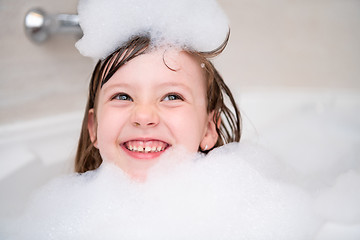 Image showing little girl in bath playing with foam