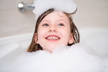 Image showing little girl in bath playing with foam