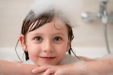 Image showing little girl in bath playing with foam