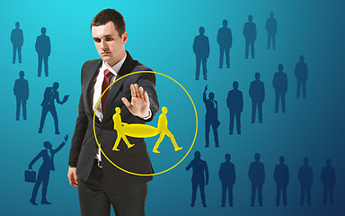 Image showing Businessman touching virtual screen on blue background