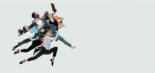 Image showing Office workers jumping isolated on studio background