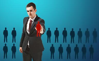 Image showing Businessman touching virtual screen on blue background