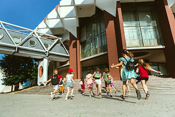 Image showing Happy kids playing at city\'s street in sunny summer\'s day