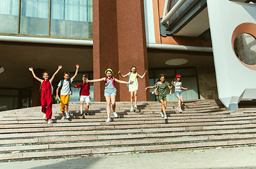 Image showing Happy kids playing at city\'s street in sunny summer\'s day