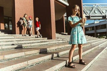 Image showing Happy kids playing at city\'s street in sunny summer\'s day