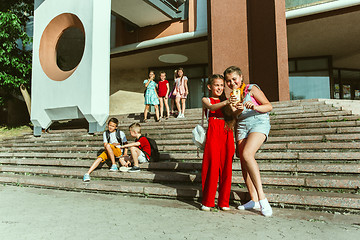 Image showing Happy kids playing at city\'s street in sunny summer\'s day