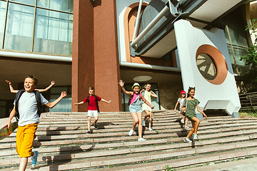 Image showing Happy kids playing at city\'s street in sunny summer\'s day