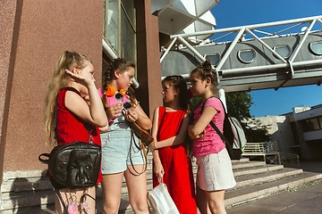 Image showing Happy kids playing at city\'s street in sunny summer\'s day