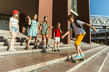 Image showing Happy kids playing at city\'s street in sunny summer\'s day