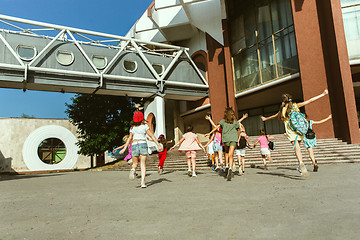 Image showing Happy kids playing at city\'s street in sunny summer\'s day