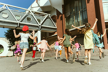 Image showing Happy kids playing at city\'s street in sunny summer\'s day